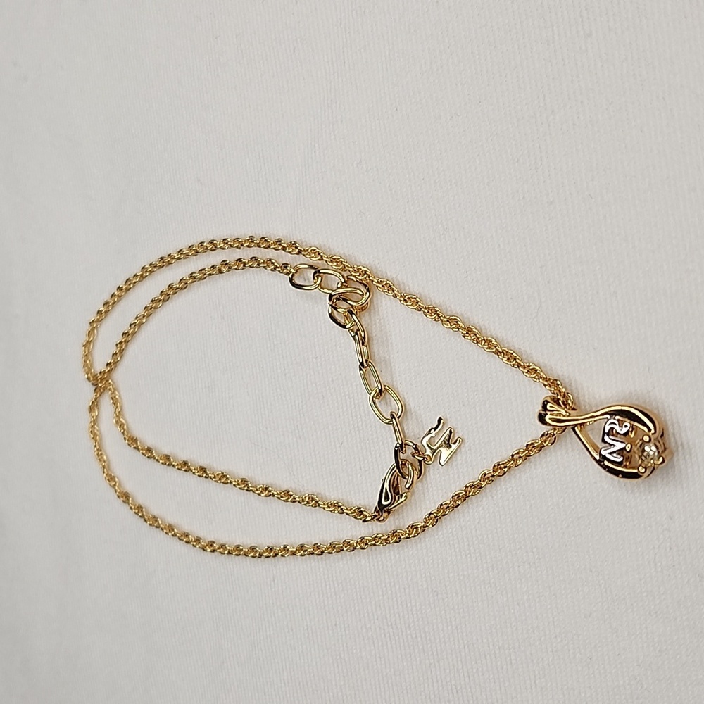 Nina Ricci 18k gold tone with stone